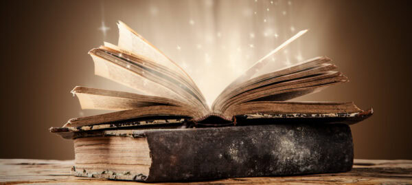 An antique book emitting a radiant light.